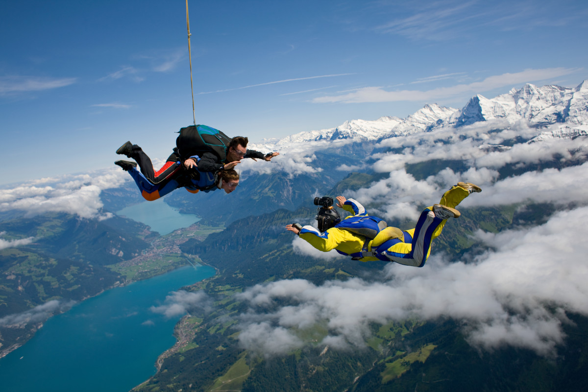 Skydivers and cameraman over Reichenbach, Bern, Switzerland